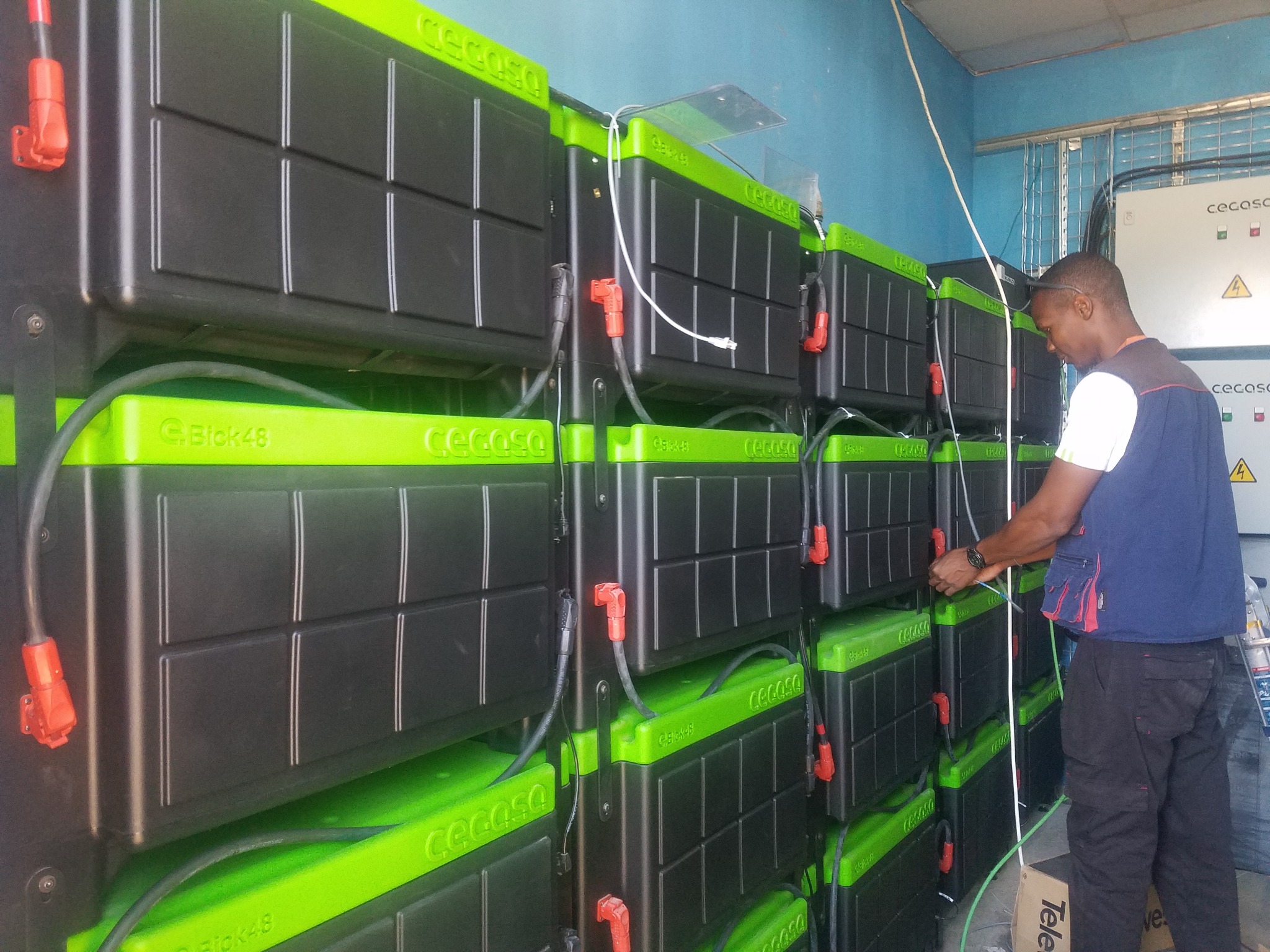 Technician working on large battery storage bank